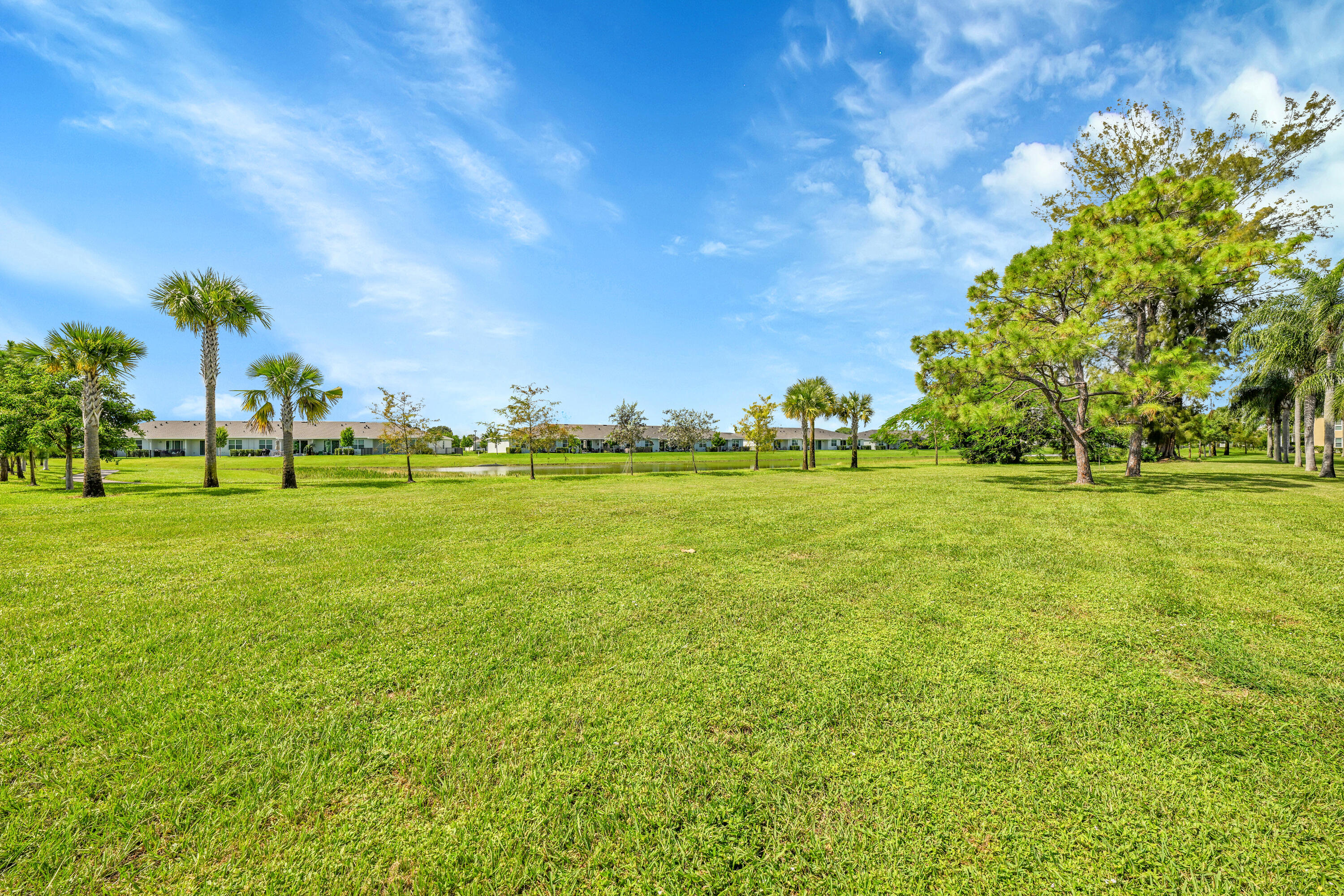 13791 Flora Place, Unit D Delray Beach, FL 33484 - Photo 22 of 24 a yard with lots of trees and plants