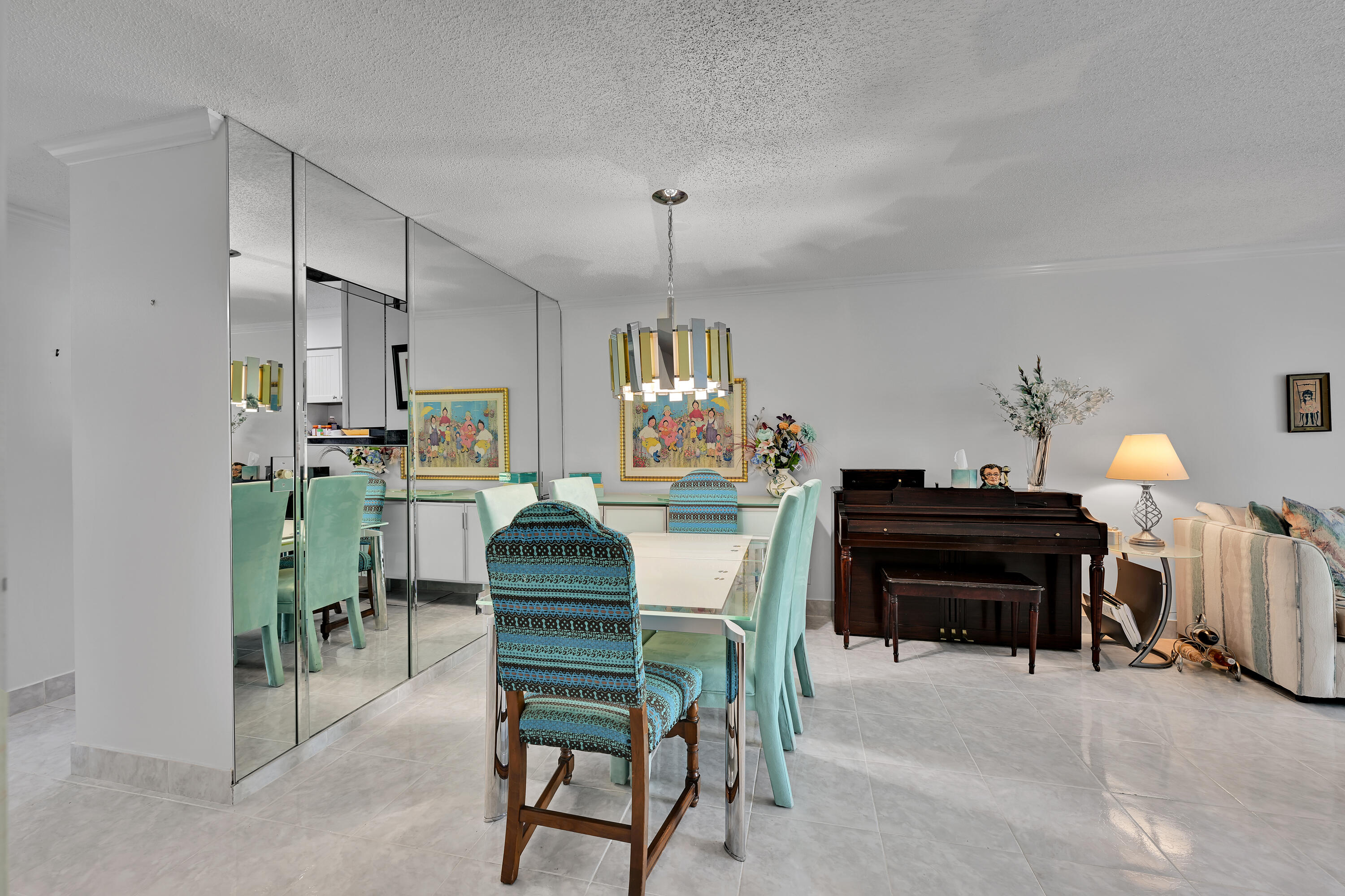 13791 Flora Place, Unit D Delray Beach, FL 33484 - Photo 6 of 24 a dining room filled with furniture and a chandelier