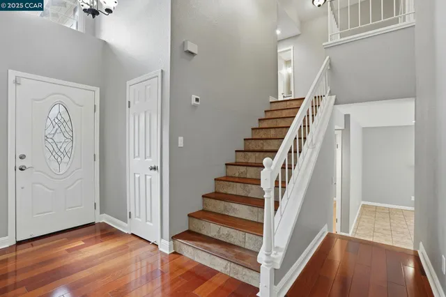a view of entryway with stairs and wooden floor