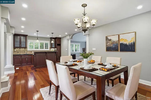 a kitchen with stainless steel appliances granite countertop a sink a refrigerator and a stove