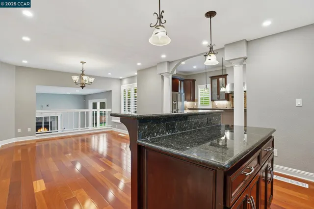 a kitchen with stainless steel appliances granite countertop a refrigerator and a sink