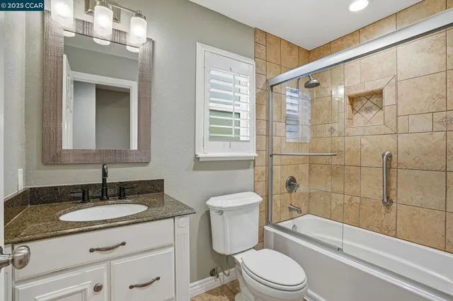 a bedroom with a bed and a potted plant