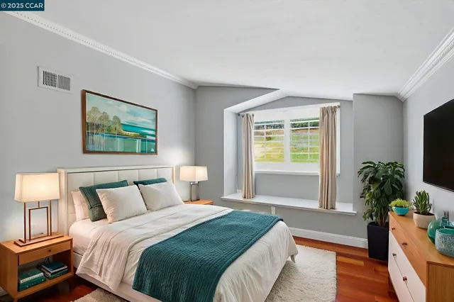 a view of a room with wooden floor and window