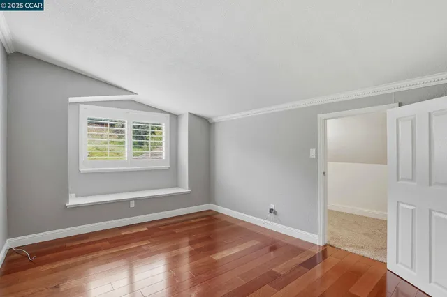 a view of an empty room with a ceiling fan