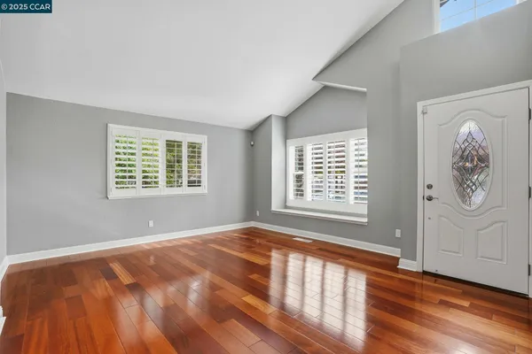 a view of an empty room with wooden floor