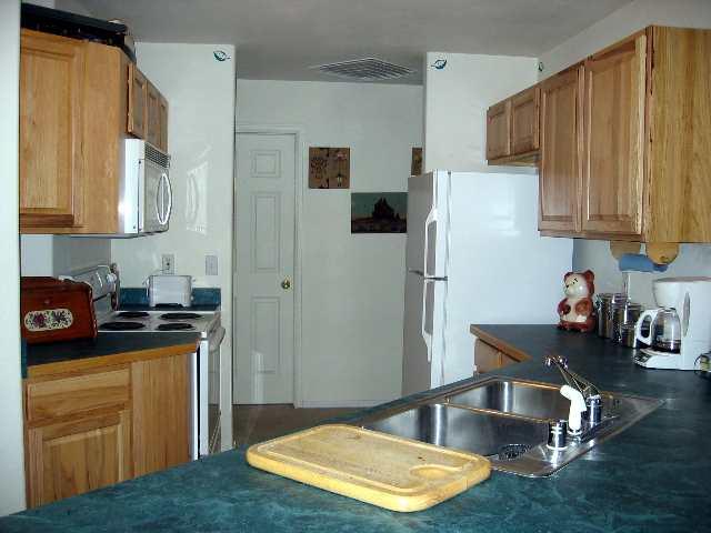 2757 Acacia Avenue Rifle, CO 81650 - Photo 5 of 9 a kitchen with sink refrigerator and cabinets