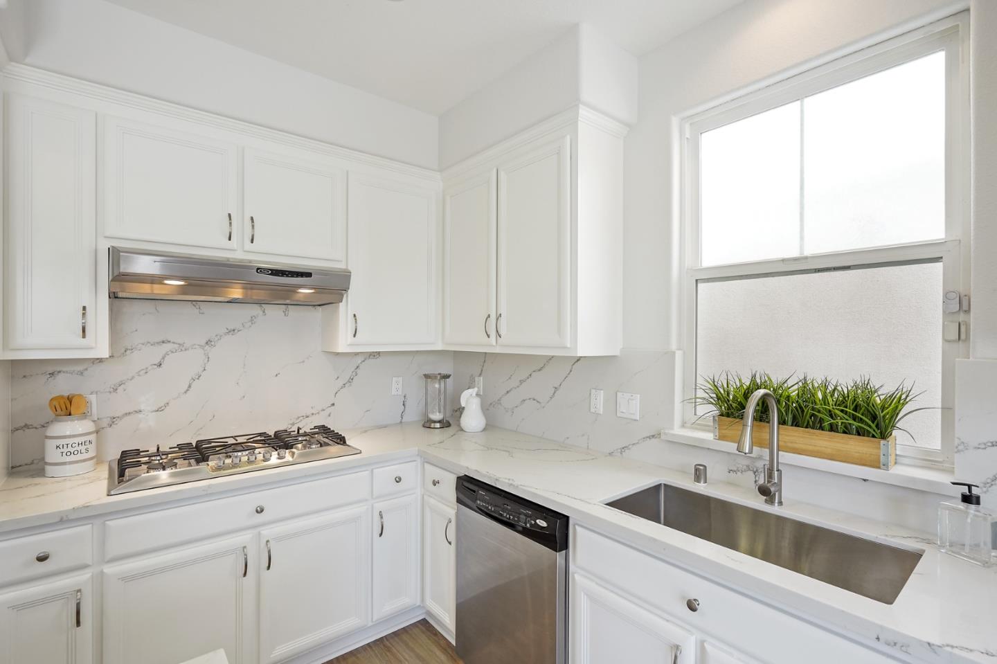 115 Cypress Street Pacifica, CA 94044 - Photo 16 of 59 a kitchen with stainless steel appliances white cabinets a sink and a window