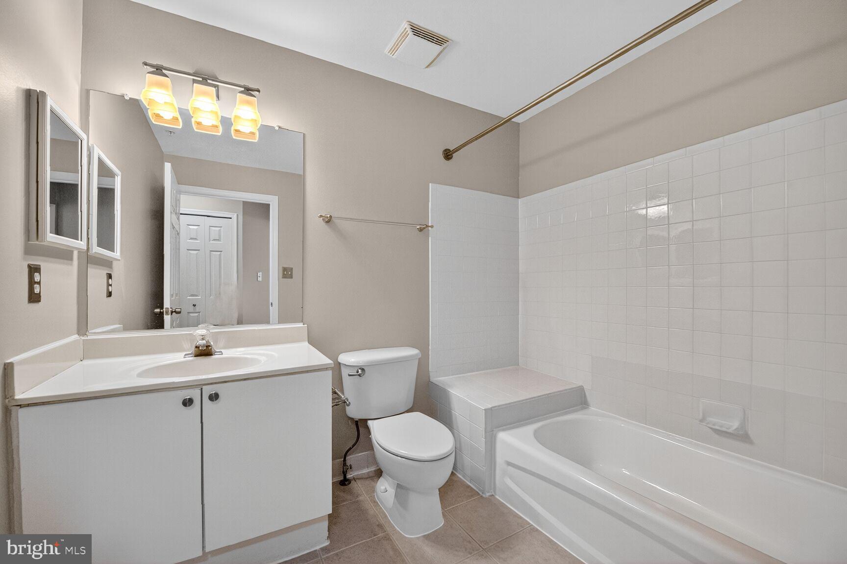 44084 Natalie Terrace, Unit 301 Ashburn, VA 20147 - Photo 11 of 15 a bathroom with a sink toilet tub and shower