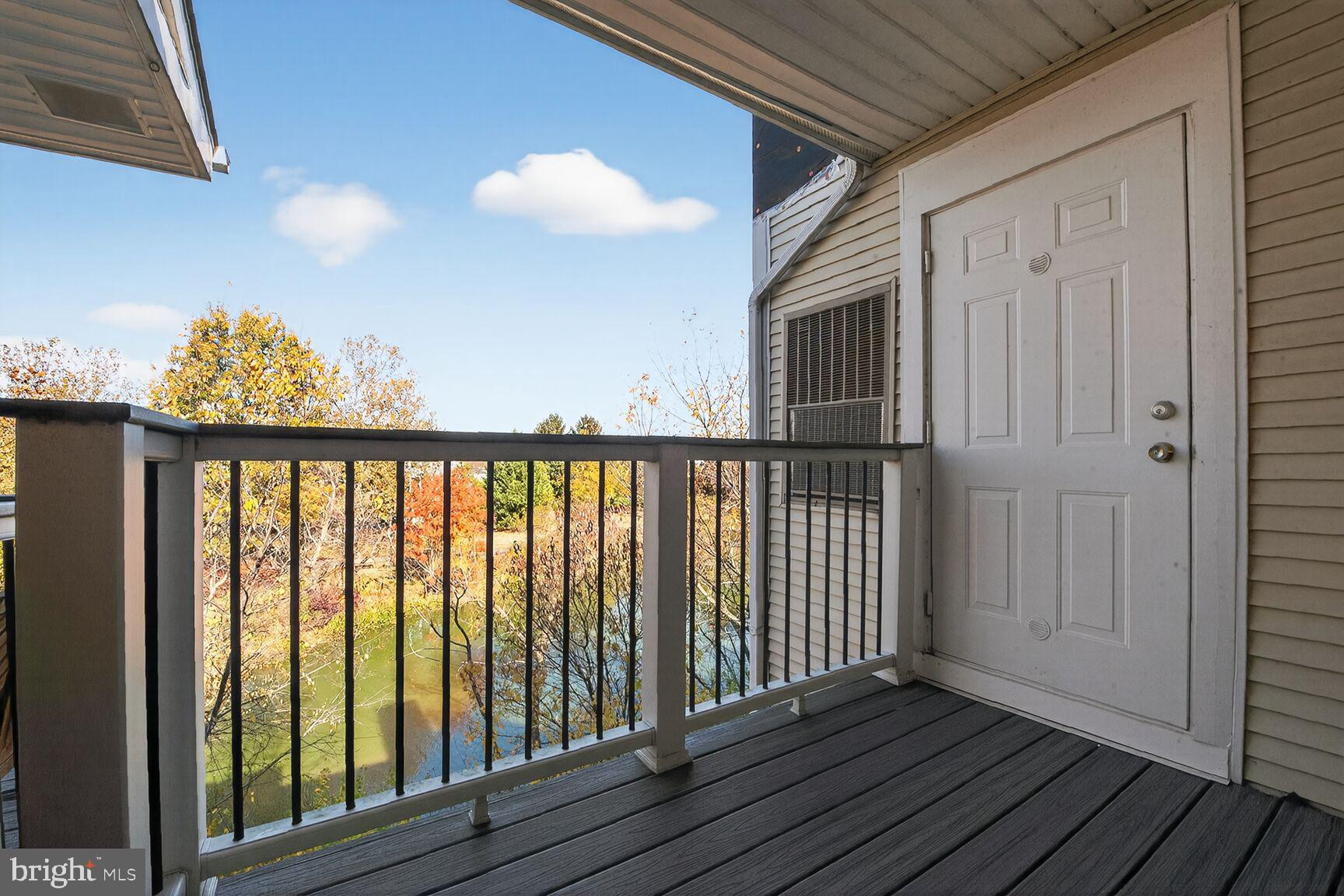 44084 Natalie Terrace, Unit 301 Ashburn, VA 20147 - Photo 13 of 15 a view of a balcony with wooden floor