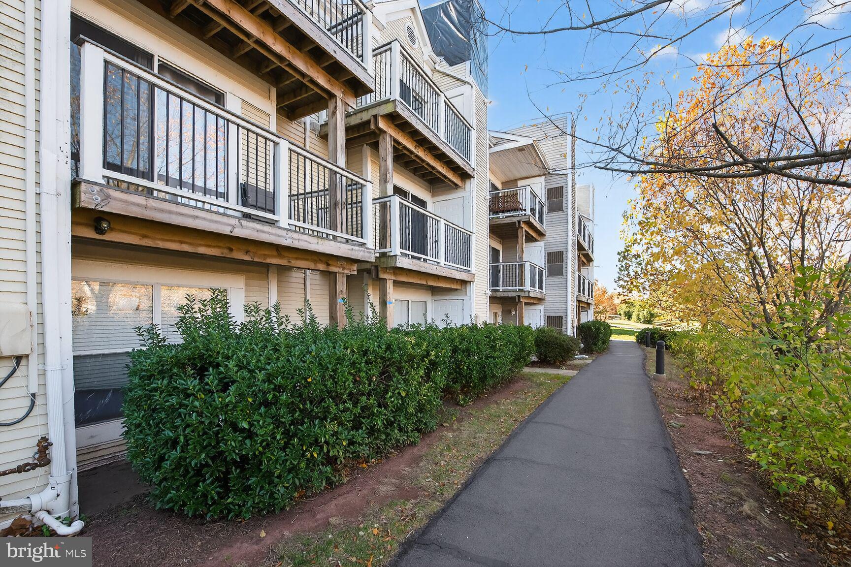 44084 Natalie Terrace, Unit 301 Ashburn, VA 20147 - Photo 15 of 15 a view of a brick building next to a yard