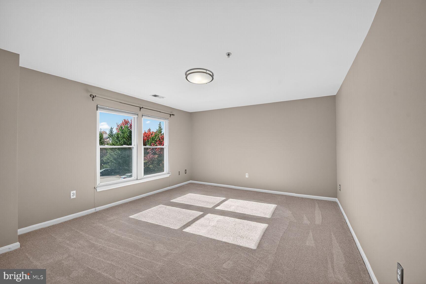 44084 Natalie Terrace, Unit 301 Ashburn, VA 20147 - Photo 7 of 15 a view of an empty room with a window