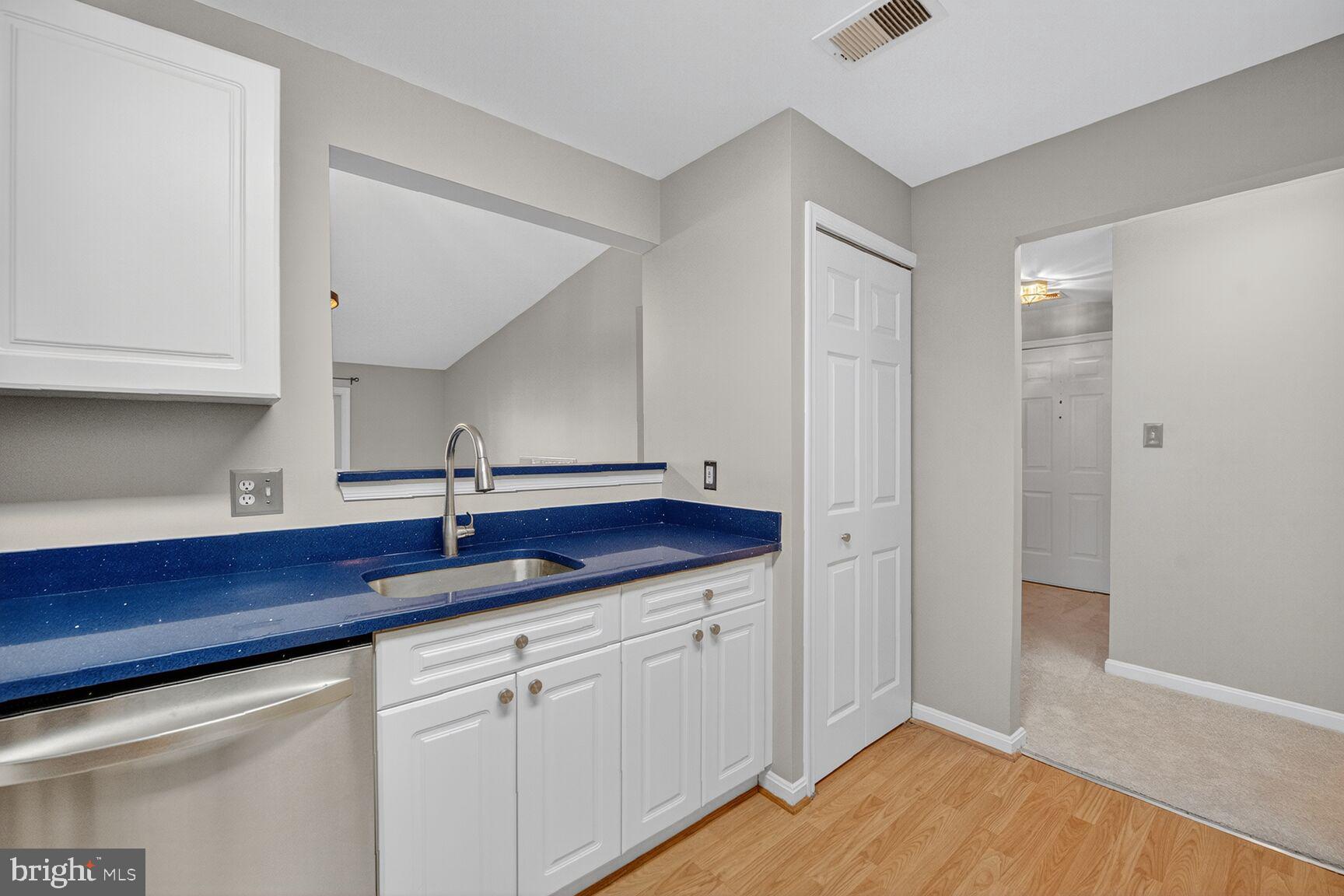 44084 Natalie Terrace, Unit 301 Ashburn, VA 20147 - Photo 9 of 15 a kitchen with a sink and cabinets