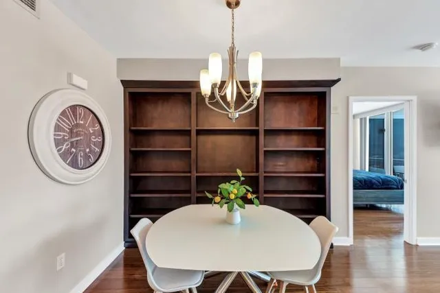 a view of a room that has a table and a chair