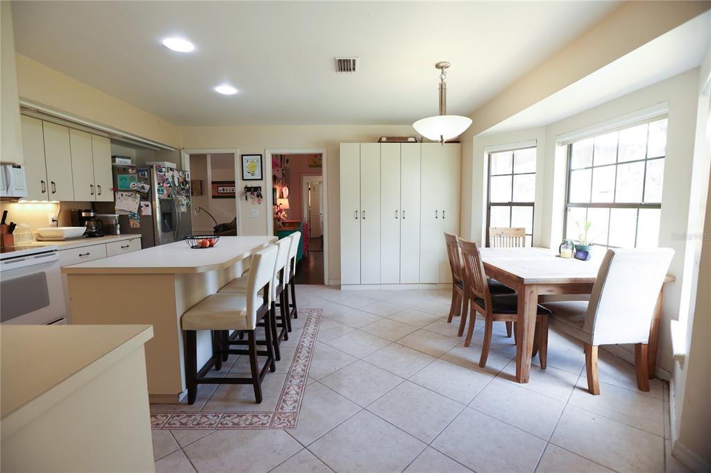 11923 Lake Butler Boulevard Windermere, FL 34786 - Photo 12 of 31 a dining room with furniture a chandelier and kitchen view