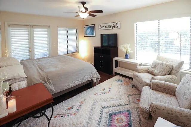 a bedroom with bed and windows