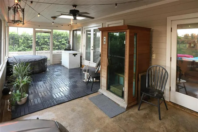 a view of a porch with chairs and backyard