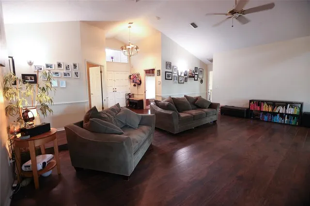 a living room with furniture window and a wooden floor