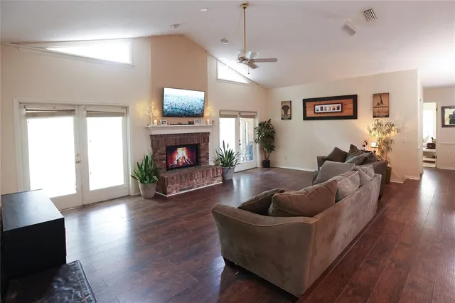 a living room with furniture a fireplace and a flat screen tv