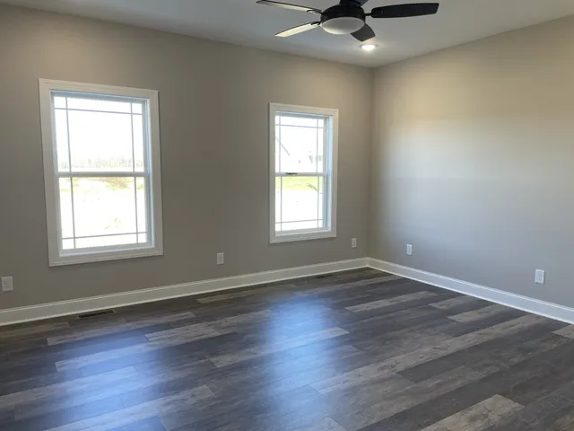 a view of a hallway with a livingroom and a bathroom
