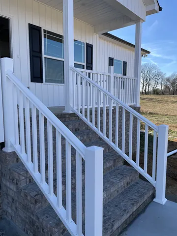 a black car parked in front of a house