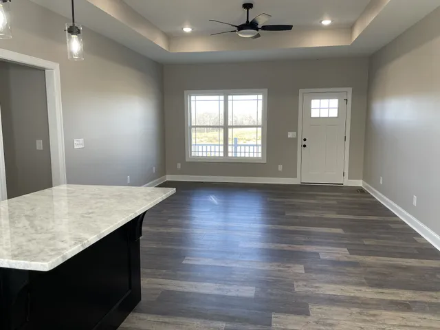 a kitchen with kitchen island granite countertop a sink appliances and cabinets