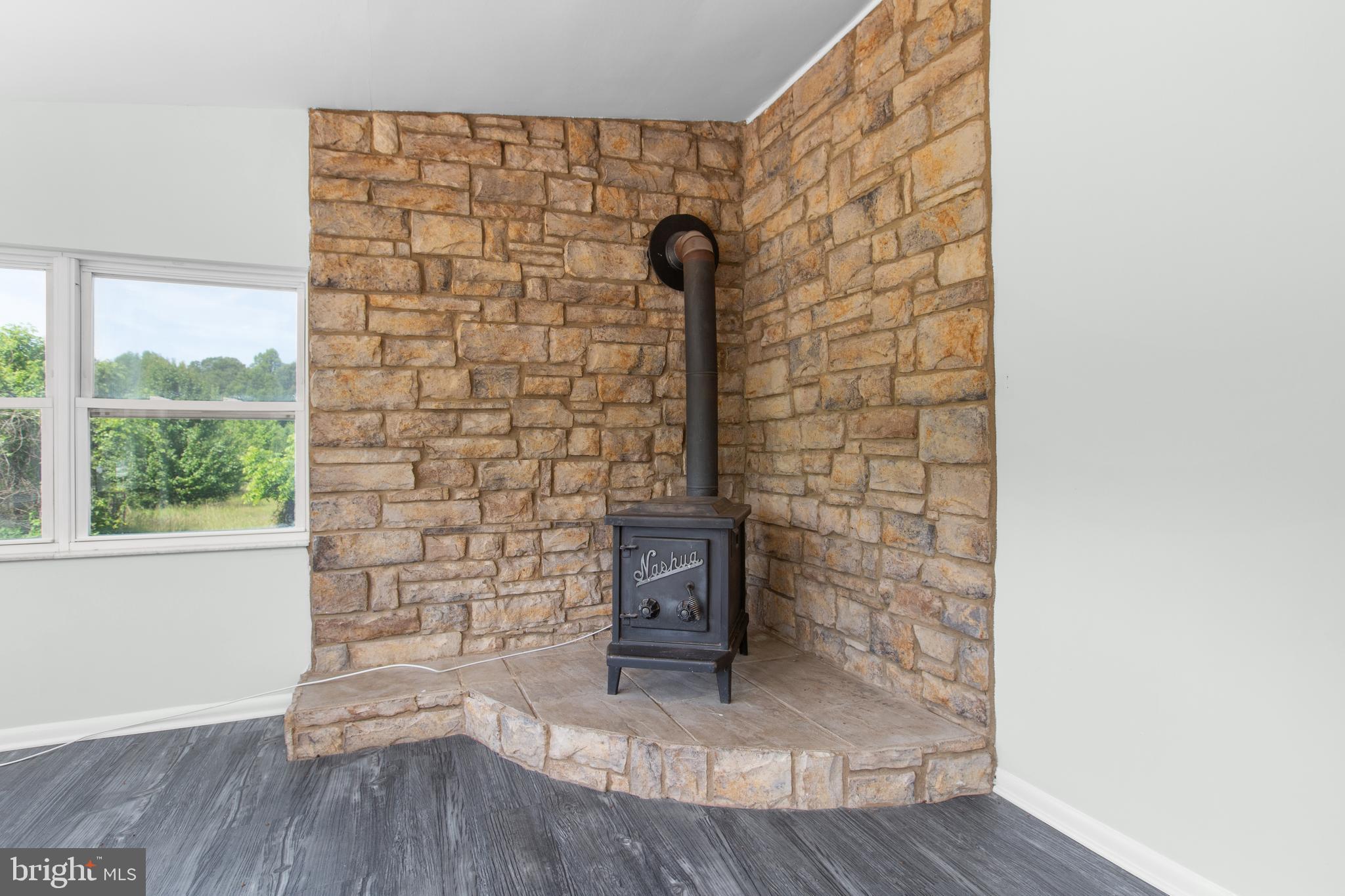 10827 Catharpin Road Spotsylvania, VA 22553 - Photo 13 of 39 a view of a hallway with wooden floor and a fireplace