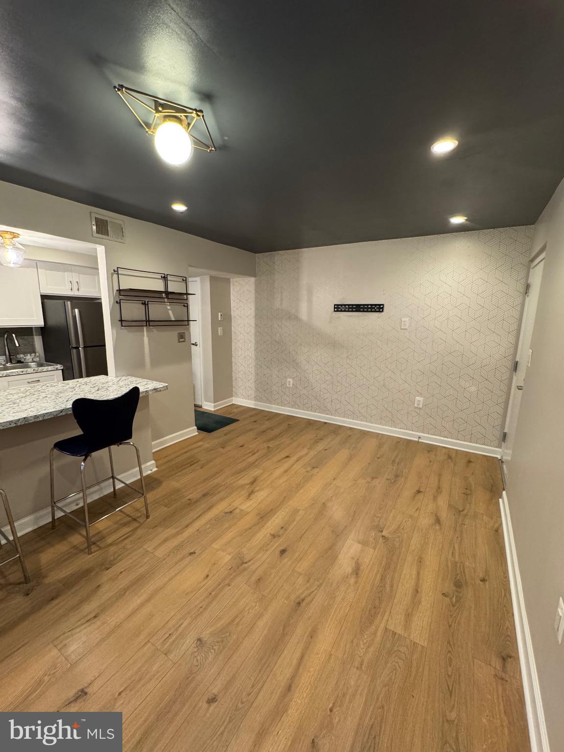 2655 Birney Place Southeast, Unit 101 Washington, DC 20020 - Photo 20 of 33 an empty room with wooden floor and windows