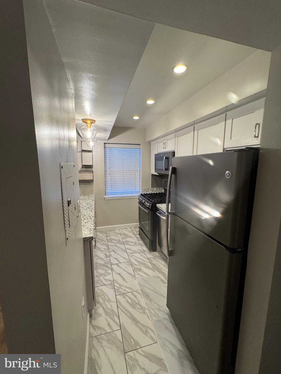 2655 Birney Place Southeast, Unit 101 Washington, DC 20020 - Photo 24 of 33 a kitchen with stainless steel appliances a refrigerator and a counter top space