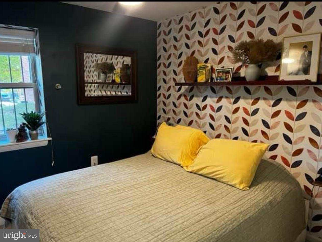 2655 Birney Place Southeast, Unit 101 Washington, DC 20020 - Photo 10 of 33 a bedroom with a bed and a potted plant