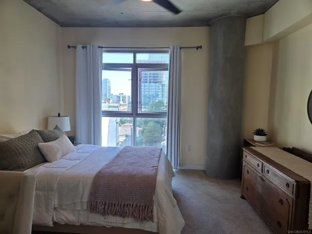 a bedroom with a bed and a window
