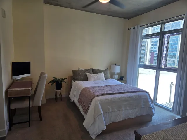 a bedroom with a bed and a window