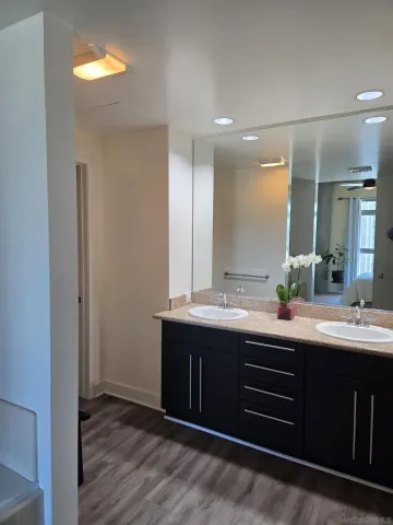 a bathroom with a double vanity sink and a mirror