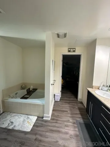 a hallway with a sink and cabinets