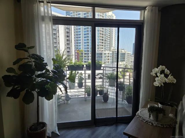 a vase of flowers sitting on a table with front door