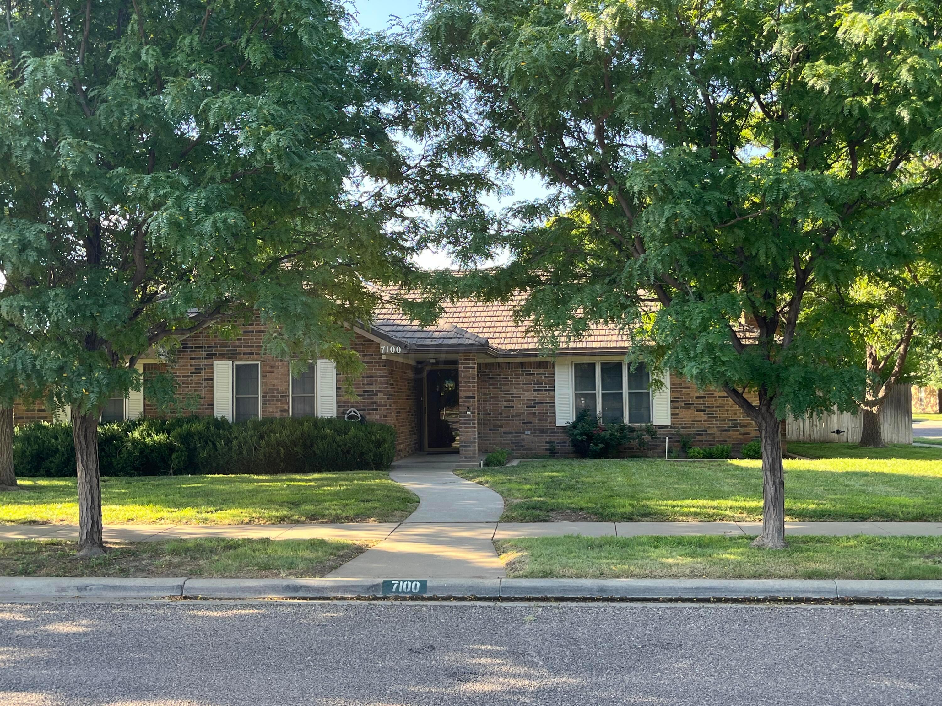 a view of a house with a large trees