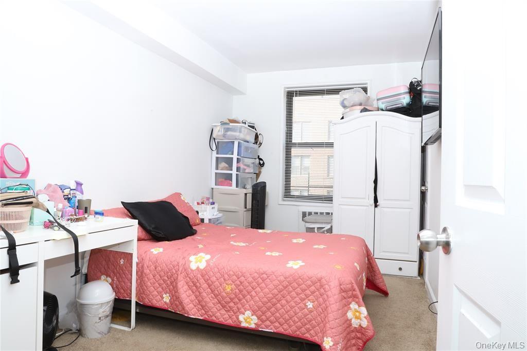 150-29 72nd Road, Unit 5C Queens, NY 11367 - Photo 12 of 34 a bedroom with a bed and a window