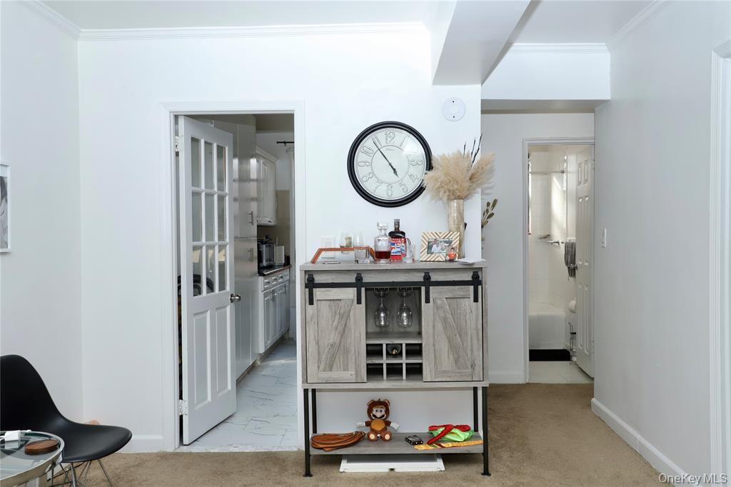 150-29 72nd Road, Unit 5C Queens, NY 11367 - Photo 13 of 34 a living room with furniture and a mirror