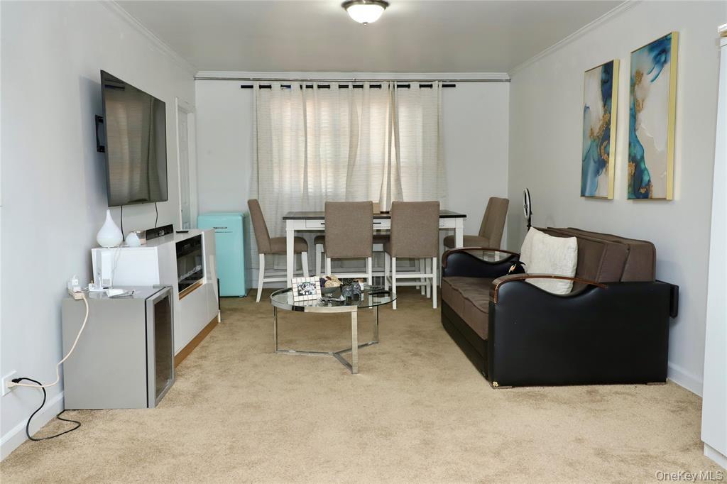 150-29 72nd Road, Unit 5C Queens, NY 11367 - Photo 2 of 34 a living room with furniture and a flat screen tv