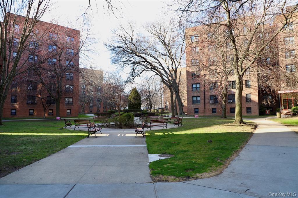 150-29 72nd Road, Unit 5C Queens, NY 11367 - Photo 22 of 34 a view of a park with bench and trees