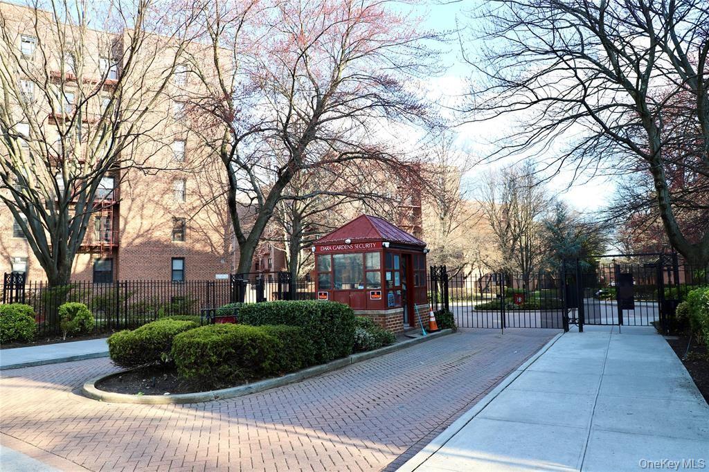 150-29 72nd Road, Unit 5C Queens, NY 11367 - Photo 29 of 34 a front view of a building with trees and cars