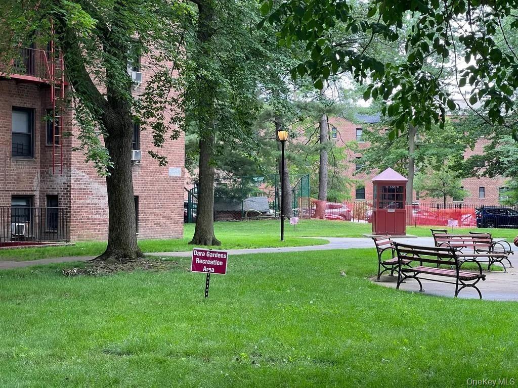 150-29 72nd Road, Unit 5C Queens, NY 11367 - Photo 32 of 34 a backyard of a house with table and chairs