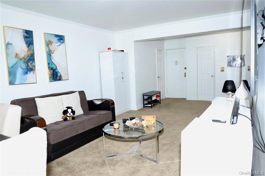 150-29 72nd Road, Unit 5C Queens, NY 11367 - Photo 6 of 34 a living room with furniture and a table