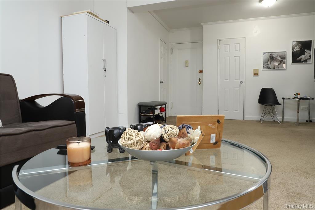 150-29 72nd Road, Unit 5C Queens, NY 11367 - Photo 7 of 34 a living room with furniture and a mirror