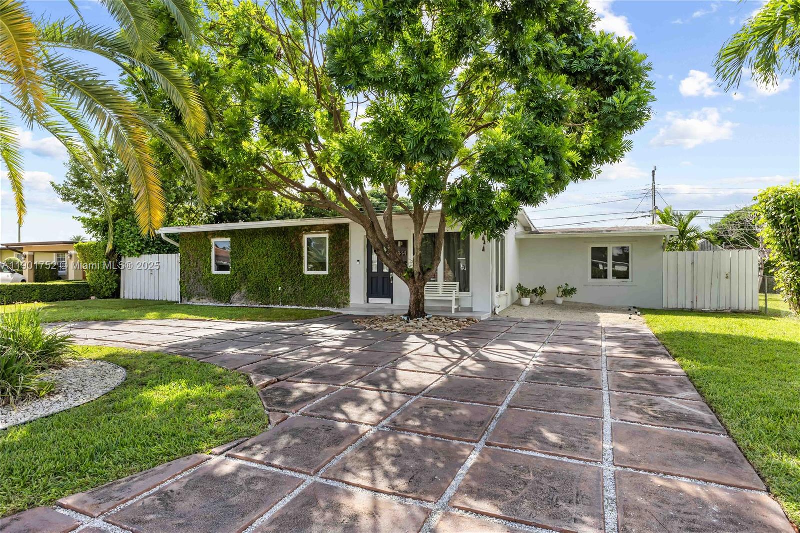a view of a yard with a house and wooden fence
