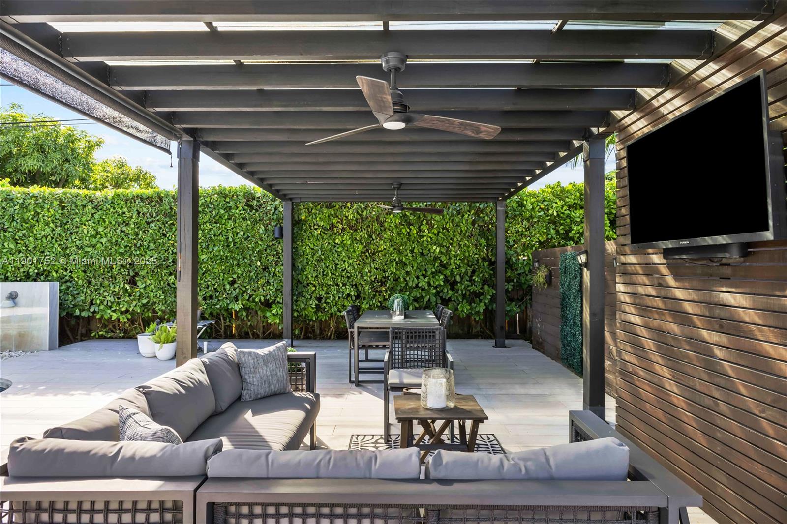 5344 Southwest 90th Court Miami, FL 33165 - Photo 7 of 13 a living room with furniture a flat screen tv and a table