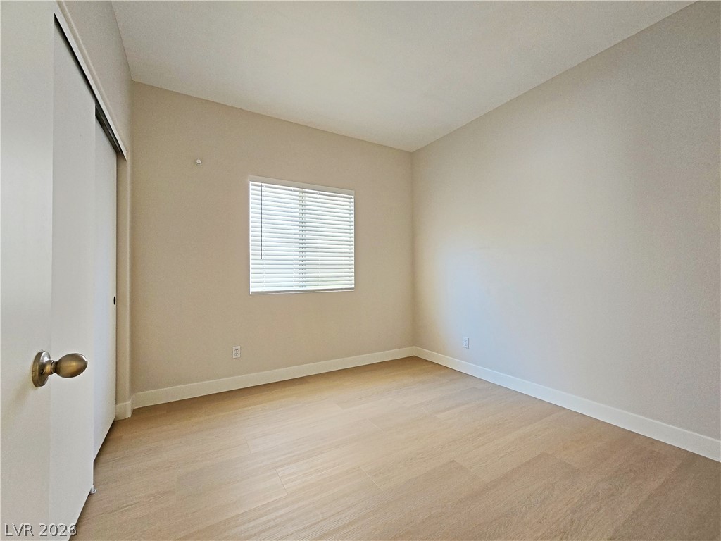 5370 Runningbrook Road Las Vegas, NV 89120 - Photo 16 of 30 A well-lit room showcasing smooth wooden flooring and clean baseboards.