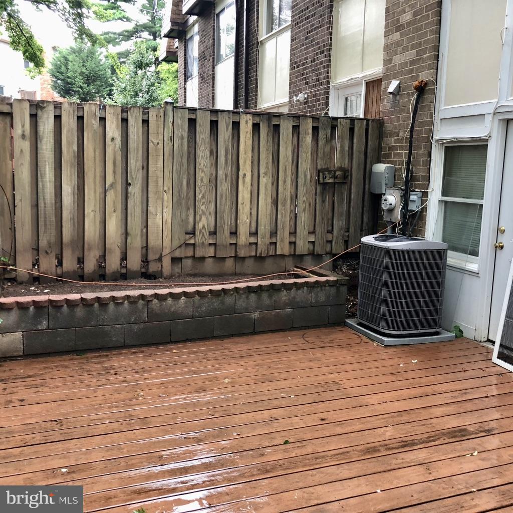 581 Summit Hall Road Gaithersburg, MD 20877 - Photo 20 of 22 a view of a terrace with wooden floor and a wooden bench