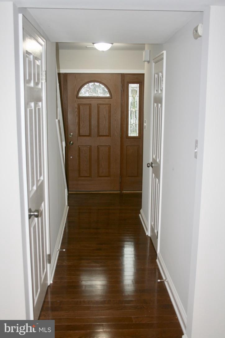 581 Summit Hall Road Gaithersburg, MD 20877 - Photo 3 of 22 a view of a hallway with wooden floor and staircase