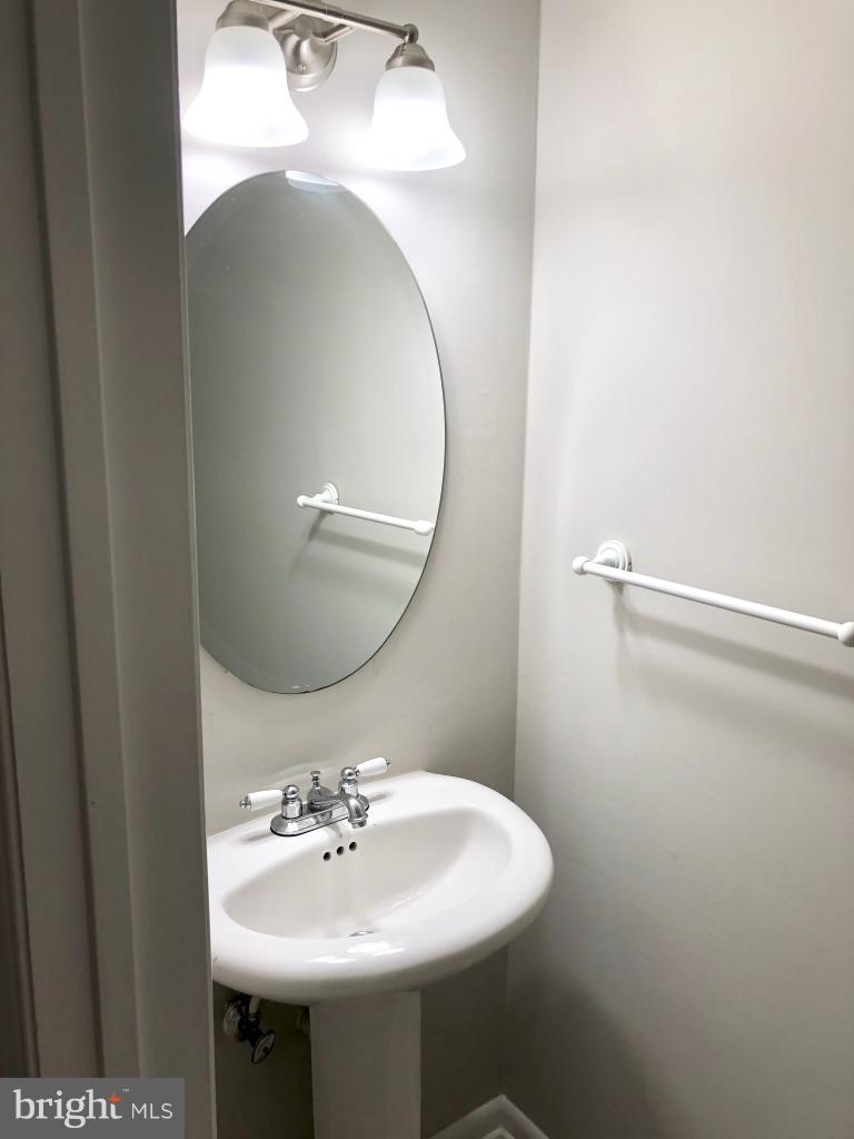 581 Summit Hall Road Gaithersburg, MD 20877 - Photo 22 of 22 a bathroom with a sink and mirror