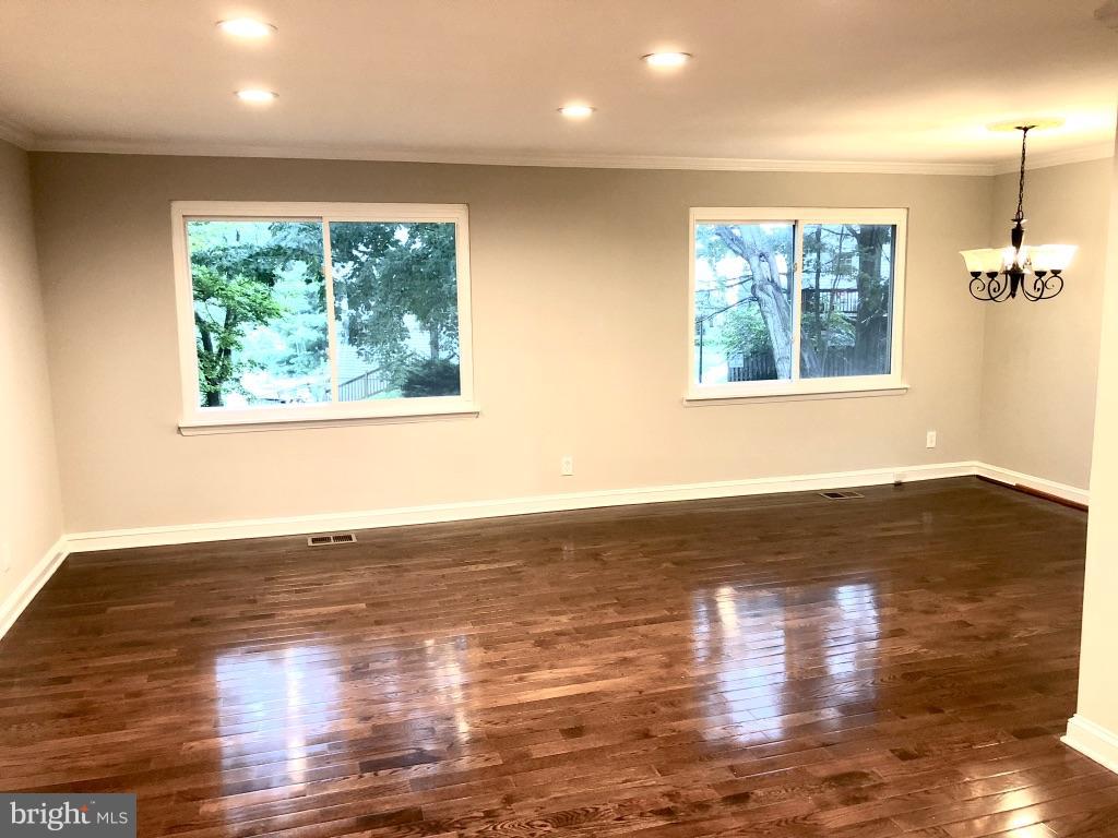 581 Summit Hall Road Gaithersburg, MD 20877 - Photo 4 of 22 a view of empty room with wooden floor and fan